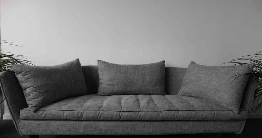 a black sofa which is three meters in length